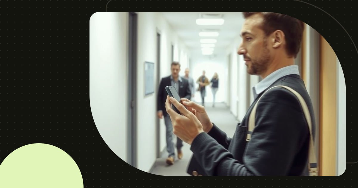 A person glancing at a website on a phone while walking through an office
